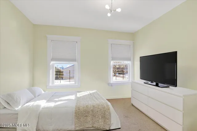 a spacious bedroom with a bed and a window