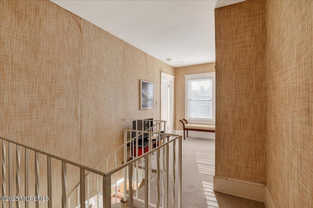 57 Hathaway Avenue Deal, NJ 07723 - Photo 32 of 37 a view of a hallway with wooden floor and a bathroom
