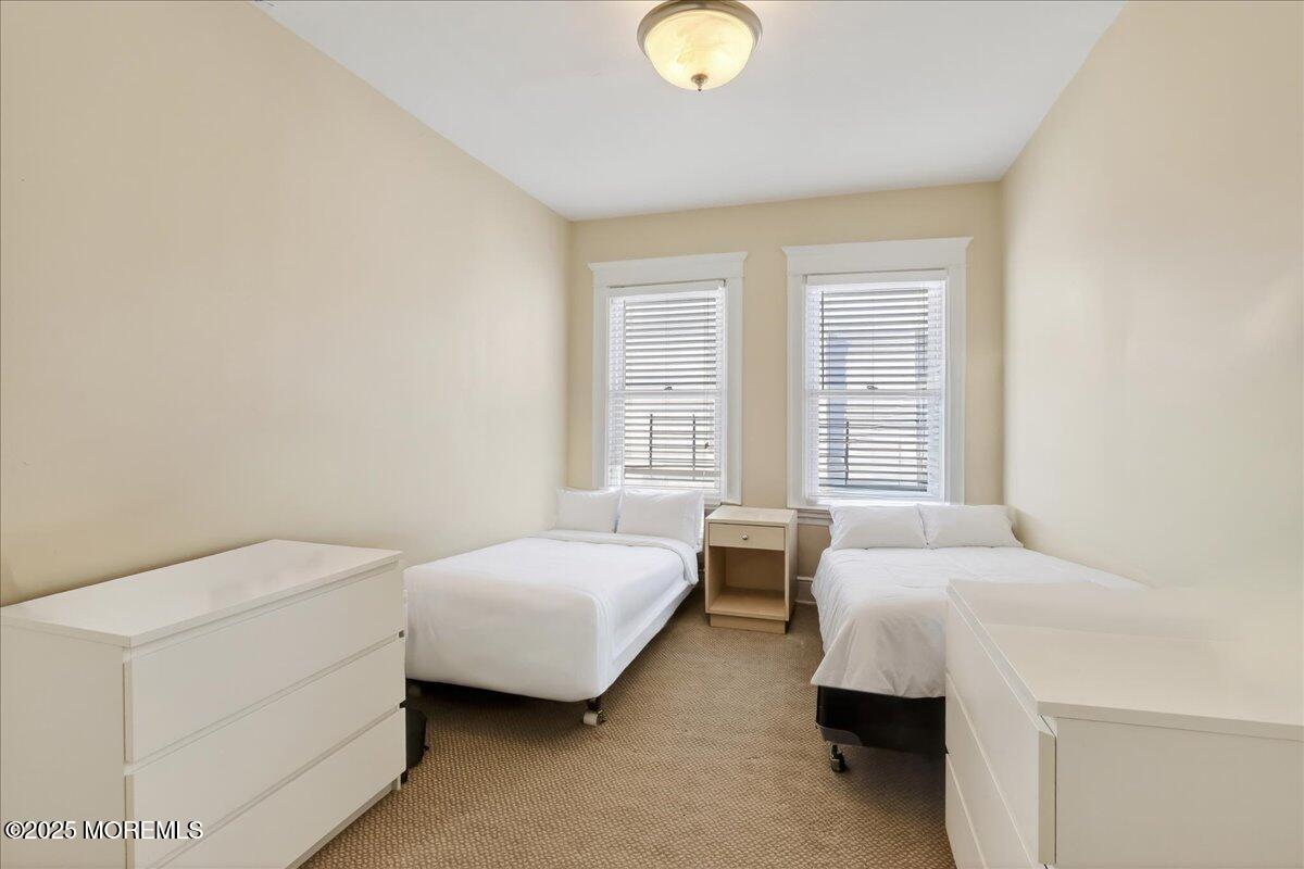 57 Hathaway Avenue Deal, NJ 07723 - Photo 7 of 37 a spacious bedroom with a bed and a window