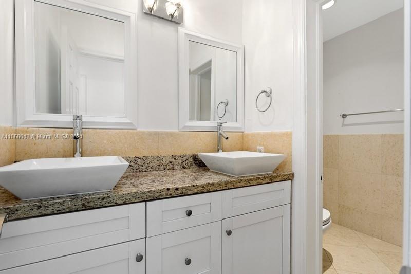 265 Glenridge Road Key Biscayne, FL 33149 - Photo 13 of 23 a bathroom with a granite countertop sink and a mirror