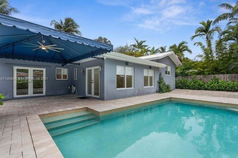265 Glenridge Road Key Biscayne, FL 33149 - Photo 2 of 23 a front view of house with yard and outdoor seating