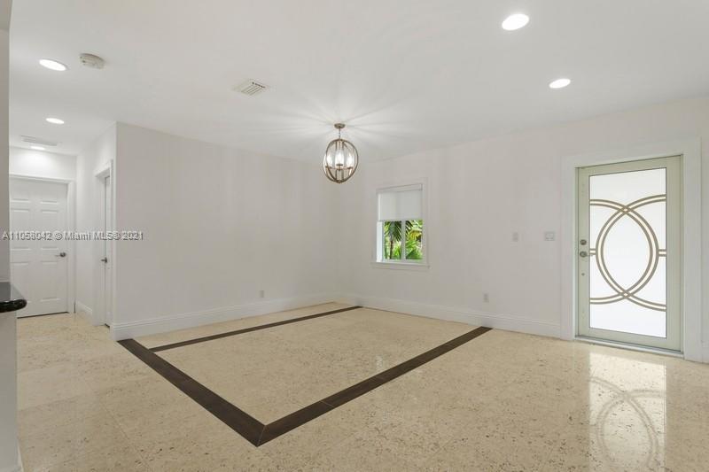 265 Glenridge Road Key Biscayne, FL 33149 - Photo 6 of 23 an empty room with windows and mirror