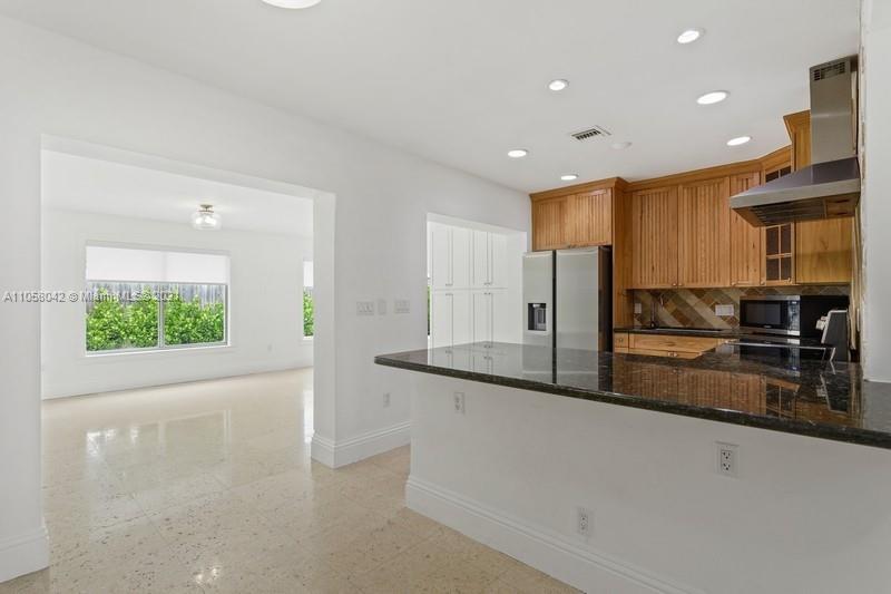 265 Glenridge Road Key Biscayne, FL 33149 - Photo 8 of 23 a kitchen with stainless steel appliances granite countertop a refrigerator and a sink