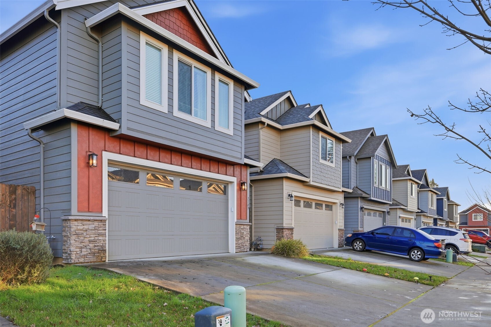 7109 South Ridge Way Ridgefield, WA 98642 - Photo 1 of 25 a front view of a house with garden