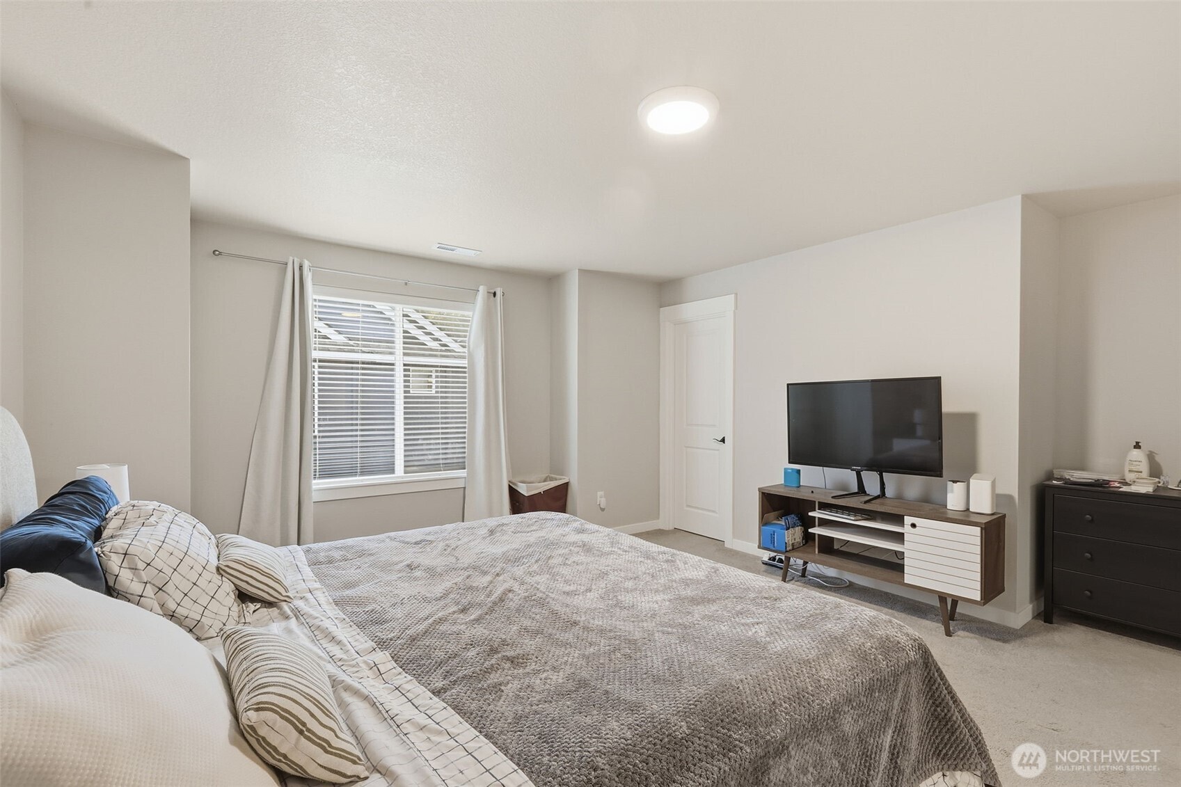 7109 South Ridge Way Ridgefield, WA 98642 - Photo 16 of 25 a bedroom with a bed and a flat screen tv