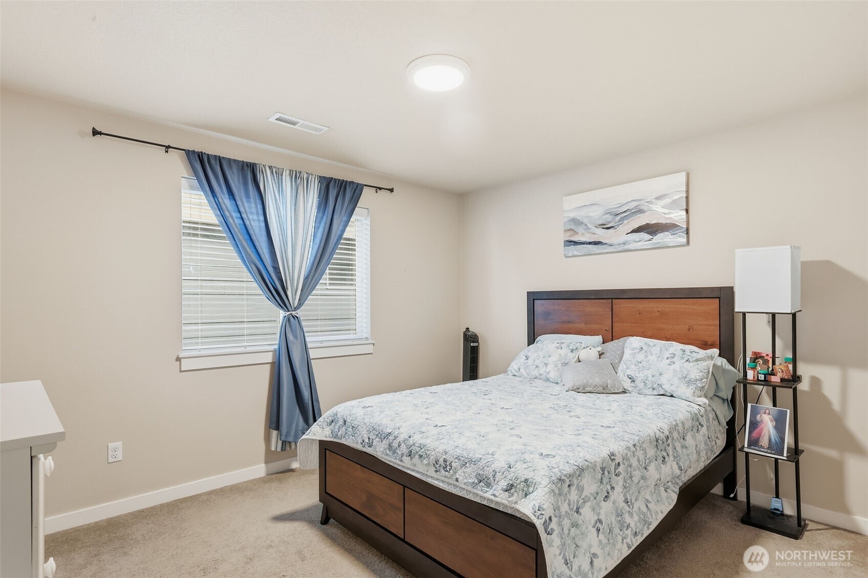 7109 South Ridge Way Ridgefield, WA 98642 - Photo 20 of 25 a bedroom with a large bed and a chandelier