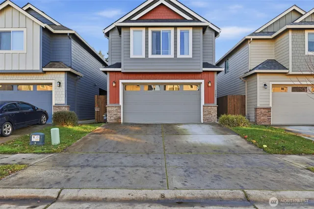 a front view of a house with a yard and garage