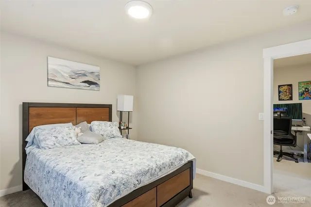 a bed sitting in a bedroom next to a window