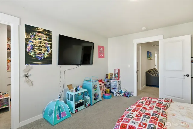 a bedroom with furniture and a flat screen tv