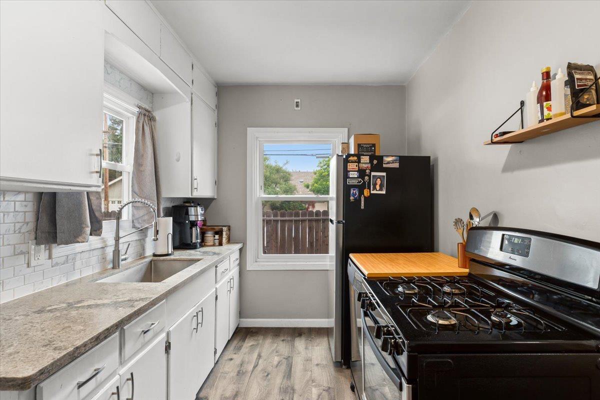 505 South Acacia Avenue Ripon, CA 95366 - Photo 19 of 38 a kitchen with stainless steel appliances granite countertop a stove a sink and a refrigerator