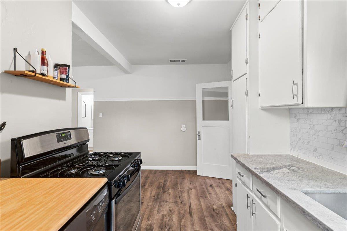 505 South Acacia Avenue Ripon, CA 95366 - Photo 21 of 38 a kitchen with granite countertop a stove and a sink