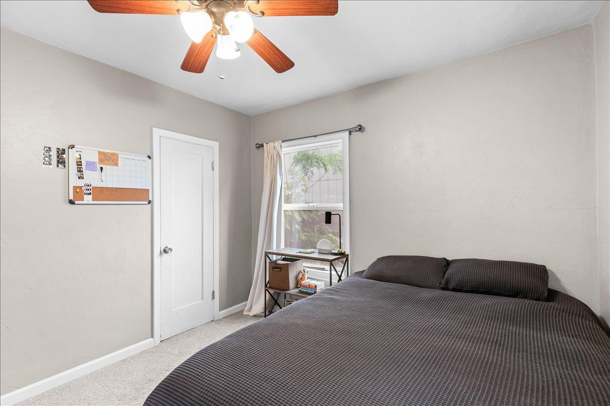 505 South Acacia Avenue Ripon, CA 95366 - Photo 28 of 38 a spacious bedroom with a bed and a chandelier