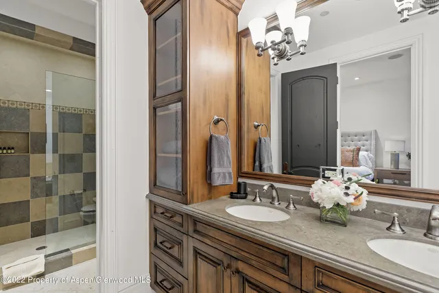 a bathroom with a sink double vanity and a mirror