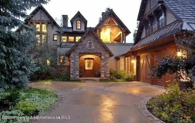 a front view of house with a garden