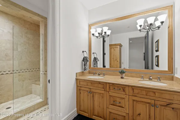 a bathroom with a double vanity sink and a mirror