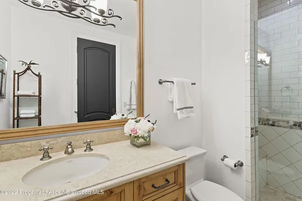 a bathroom with a sink vanity granite and toilet