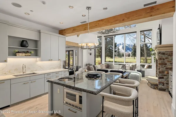 a kitchen with stainless steel appliances granite countertop a sink and a refrigerator
