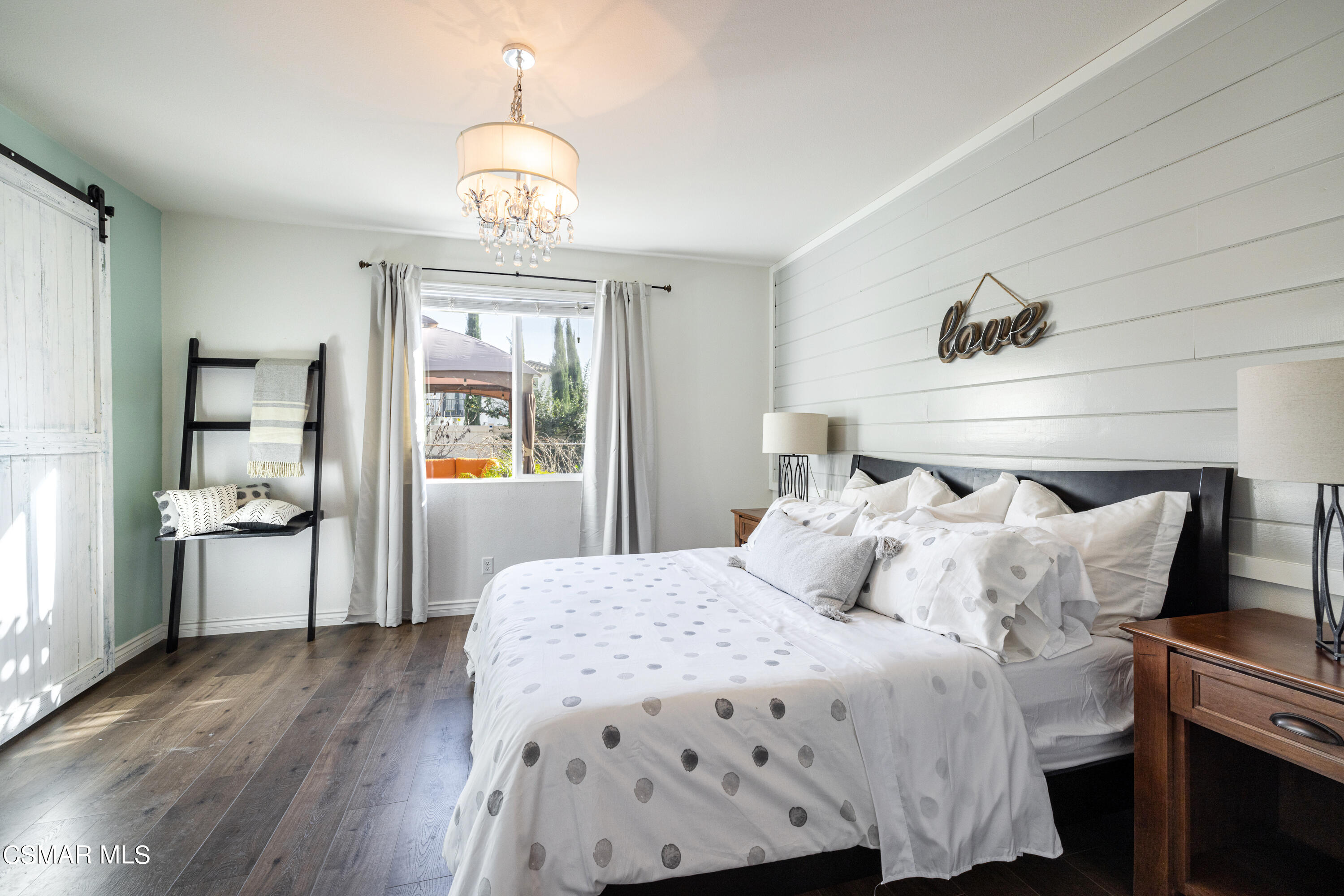 396 Edgewood Drive Fillmore, CA 93015 - Photo 11 of 29 a bedroom with a bed and a chandelier