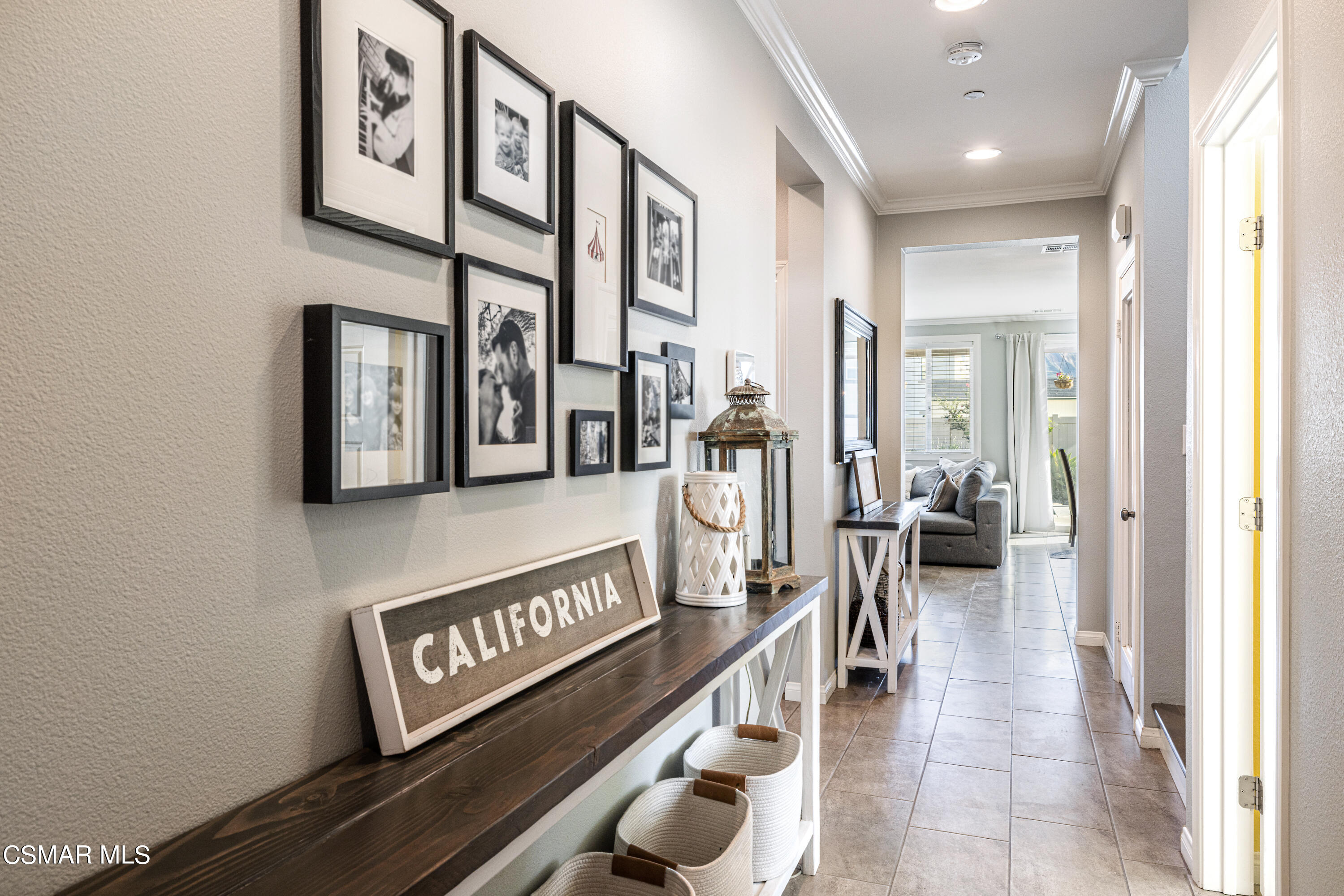396 Edgewood Drive Fillmore, CA 93015 - Photo 4 of 29 a view of a hallway with wooden floor and couches