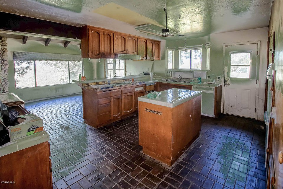 11851 Presilla Road Moorpark, CA 93021 - Photo 13 of 18 a kitchen with a sink stove and cabinets