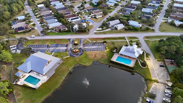 an aerial view of a house with a swimming pool outdoor seating and yard