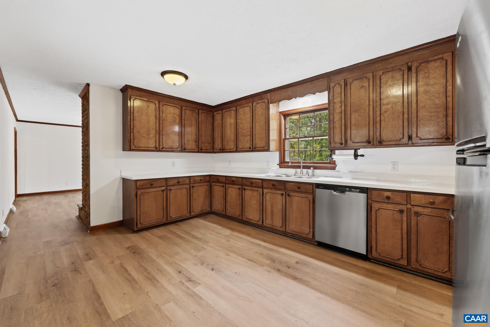 55 Watson Road Ruckersville, VA 22968 - Photo 13 of 37 a kitchen with granite countertop wooden cabinets a sink a window and stainless steel appliances