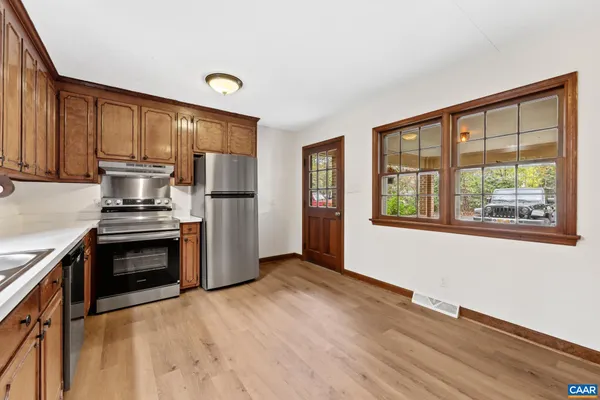 a kitchen with a refrigerator and a stove top oven