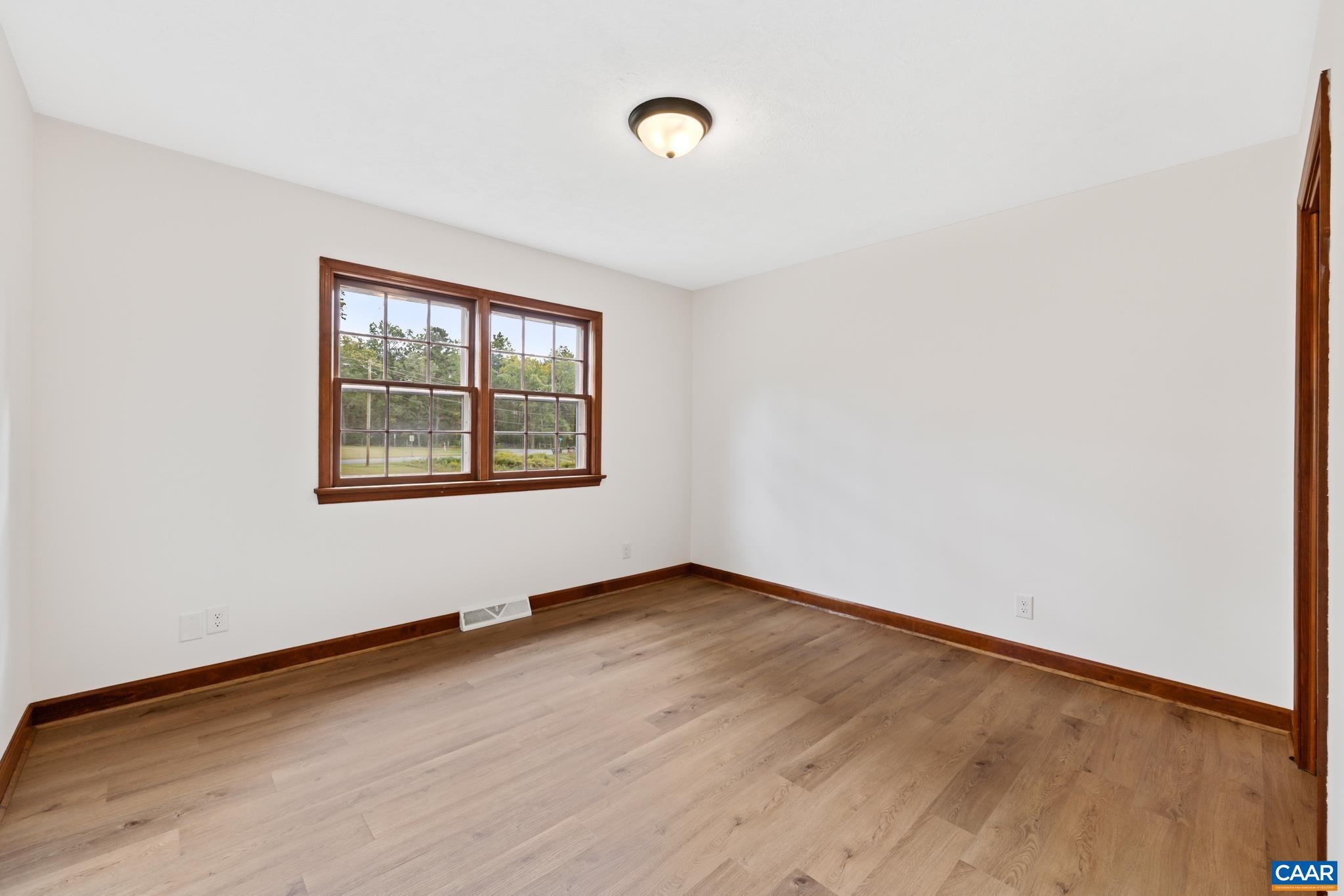 55 Watson Road Ruckersville, VA 22968 - Photo 15 of 37 an empty room with wooden floor and windows