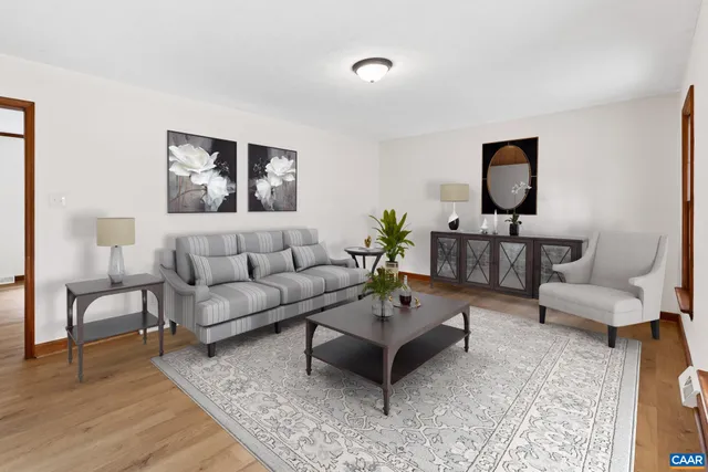 an empty room with wooden floor fireplace and windows
