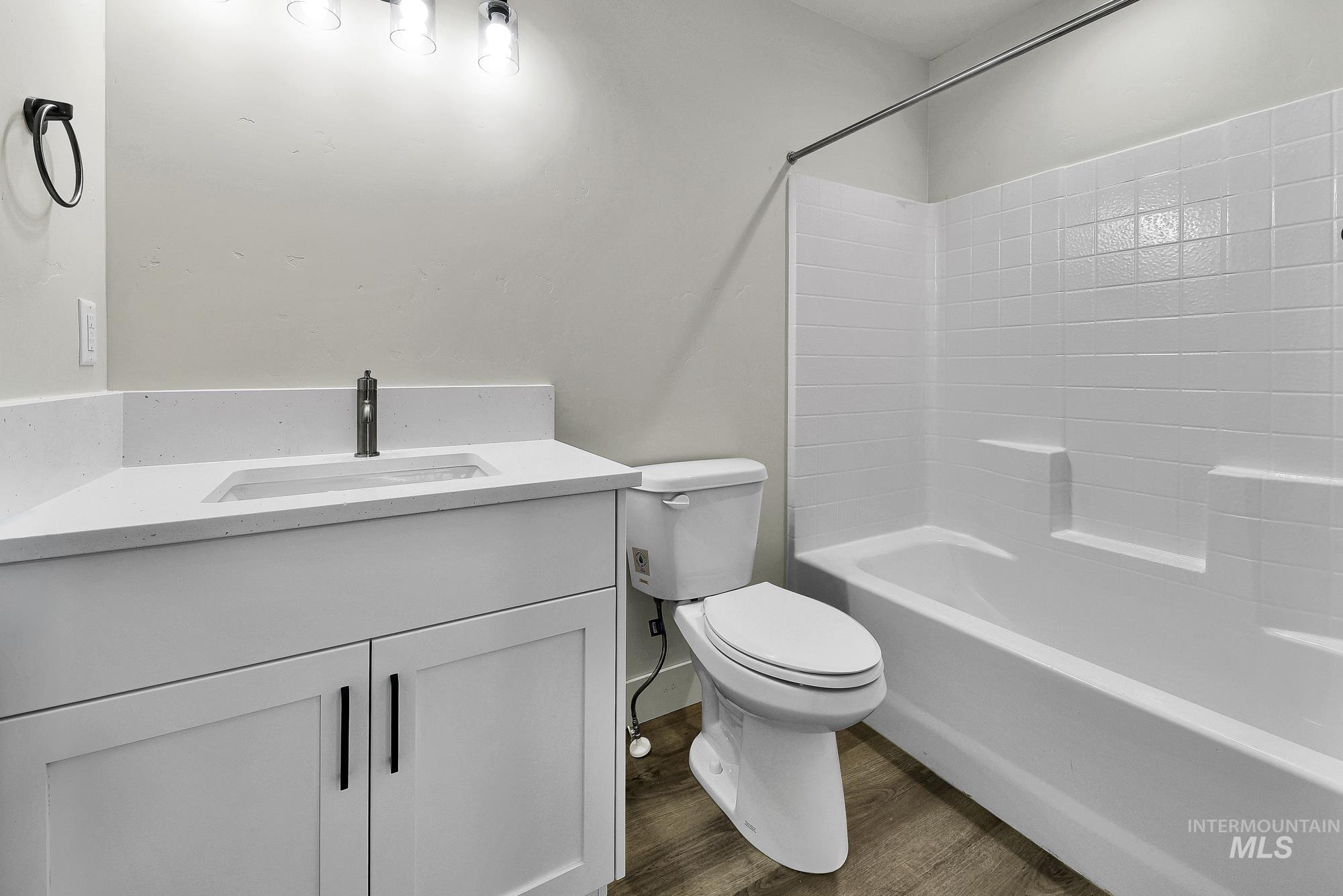 328 Packer Lane Homedale, ID 83628 - Photo 15 of 25 Bathroom featuring vanity, dark wood finished floors, and bathing tub / shower combination