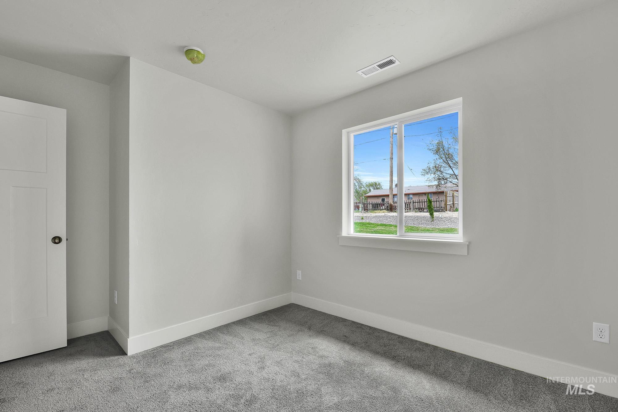 328 Packer Lane Homedale, ID 83628 - Photo 18 of 25 Empty room with light carpet and baseboards
