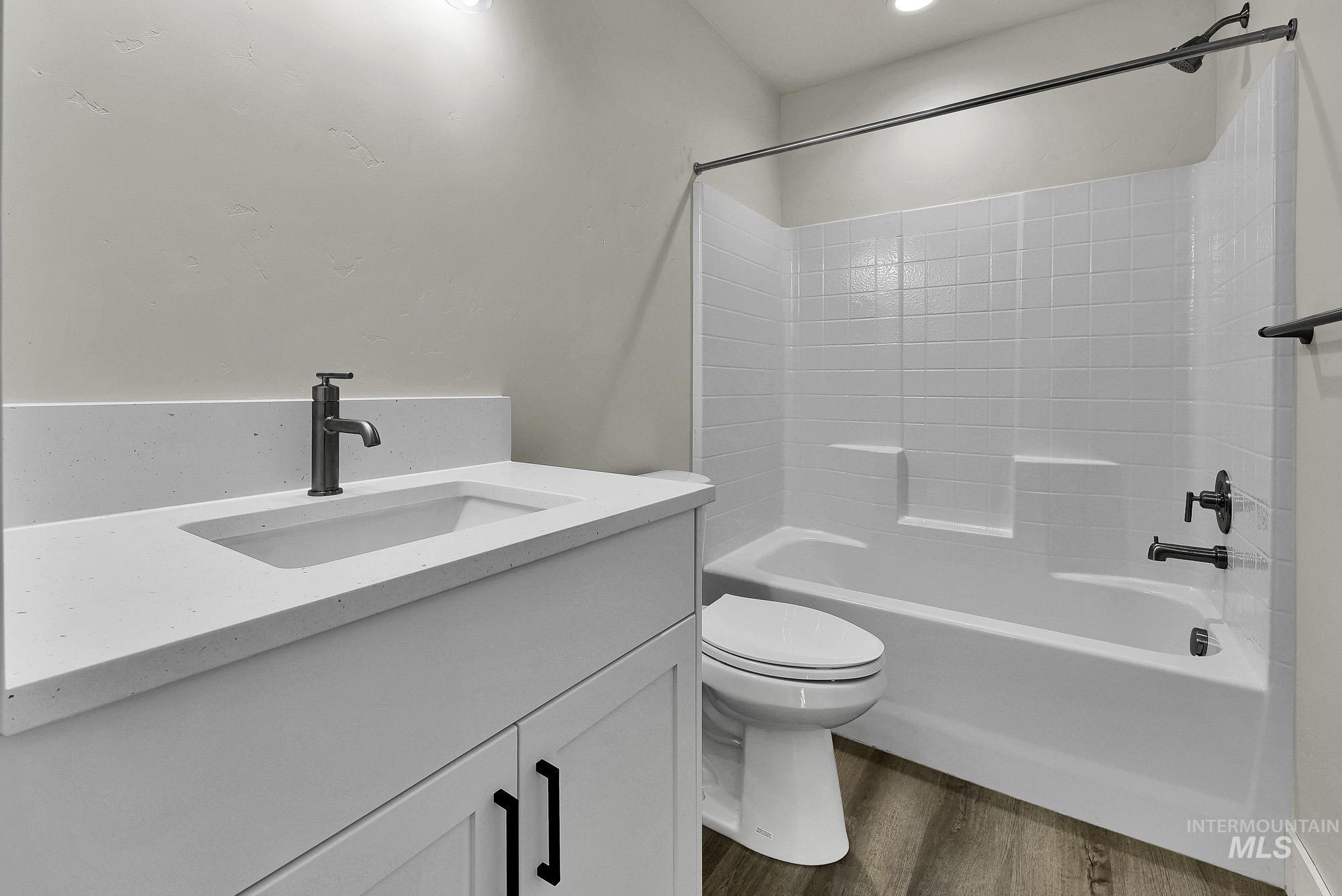 328 Packer Lane Homedale, ID 83628 - Photo 20 of 25 Full bath featuring vanity, dark wood-style flooring, and washtub / shower combination