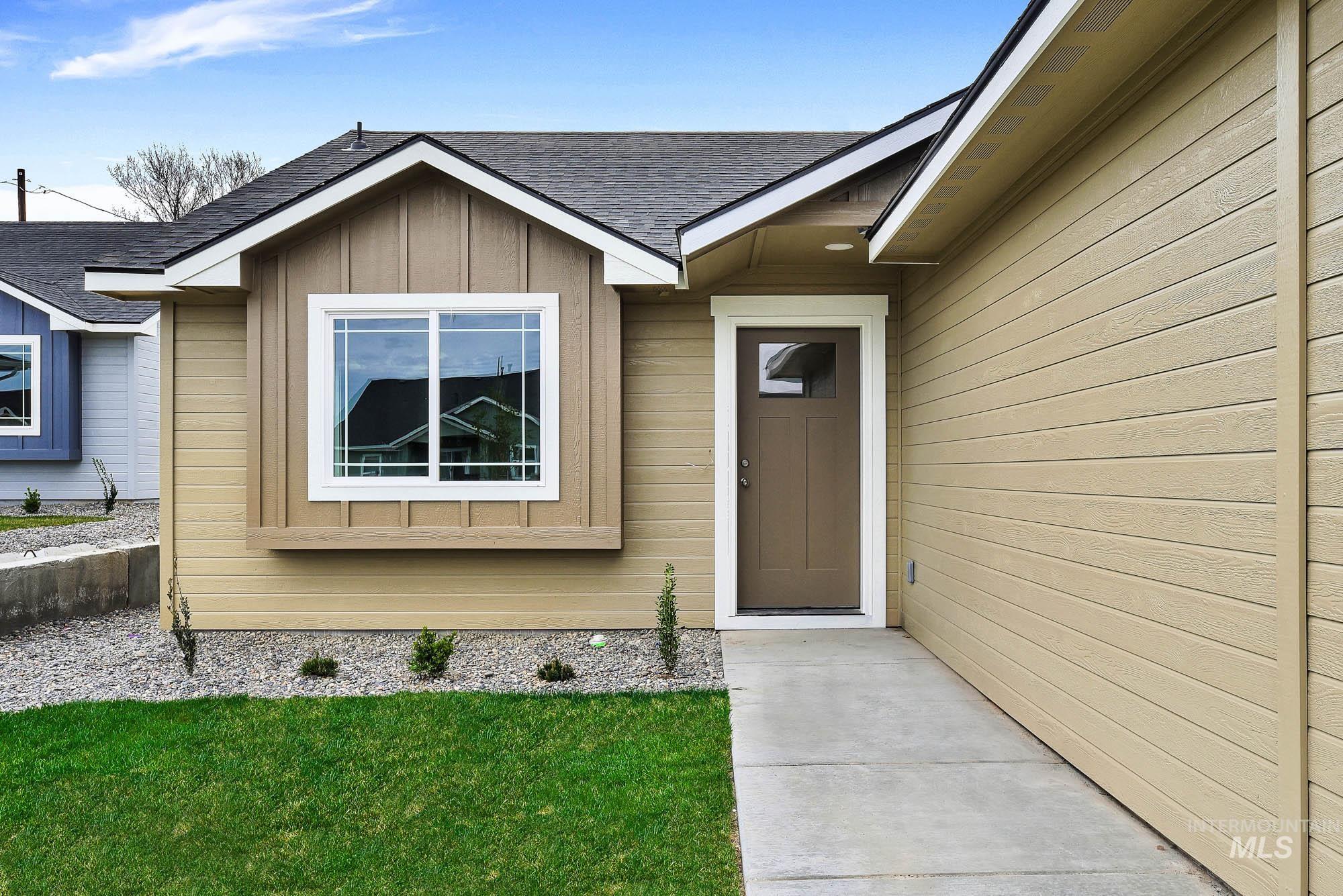 328 Packer Lane Homedale, ID 83628 - Photo 2 of 25 Entrance to property with a shingled roof, board and batten siding, and a yard