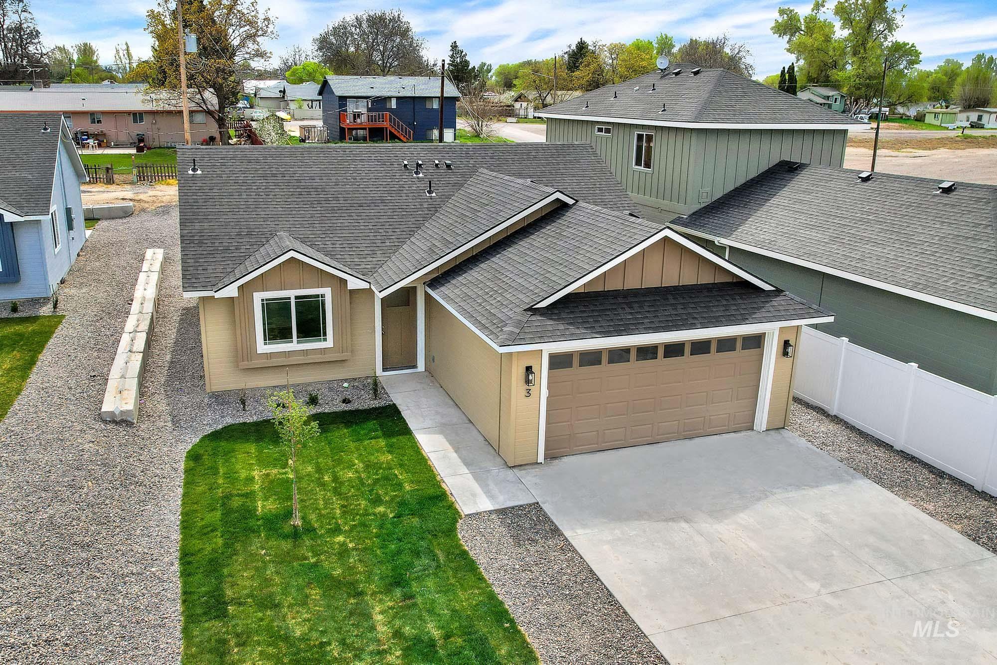328 Packer Lane Homedale, ID 83628 - Photo 23 of 25 View of front of house with a shingled roof, concrete driveway, board and batten siding, a residential view, and an attached garage