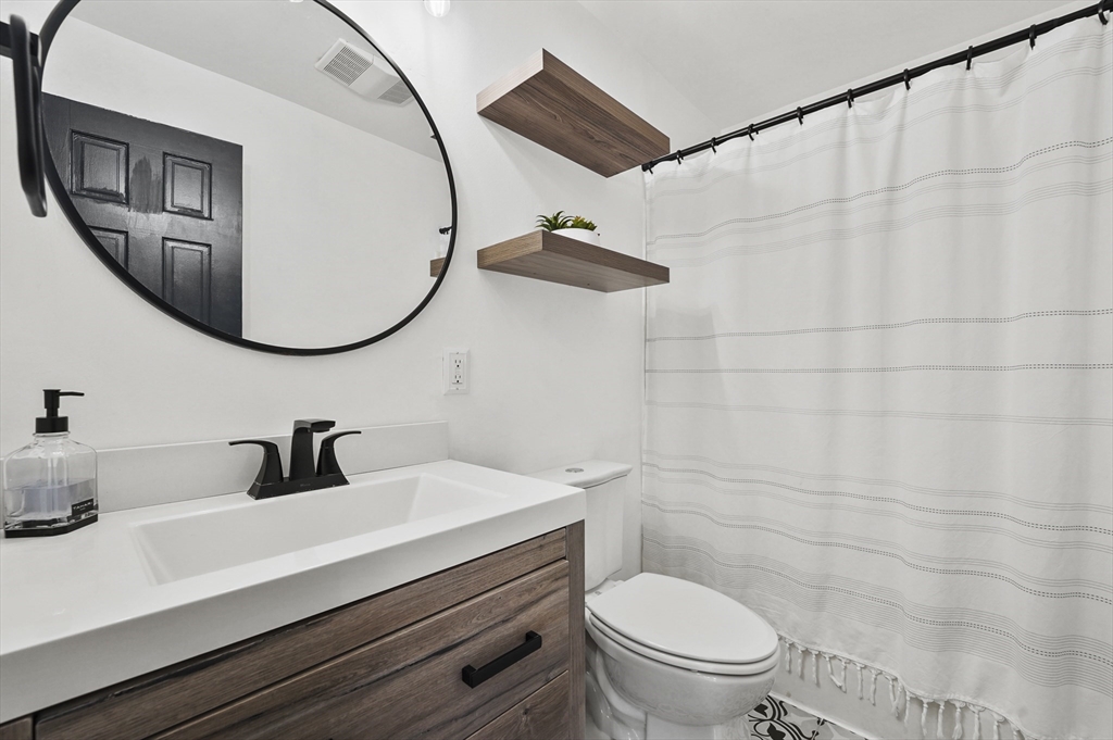 101 Prospect Street Acton, MA 01720 - Photo 13 of 21 a bathroom with a sink a toilet and a mirror