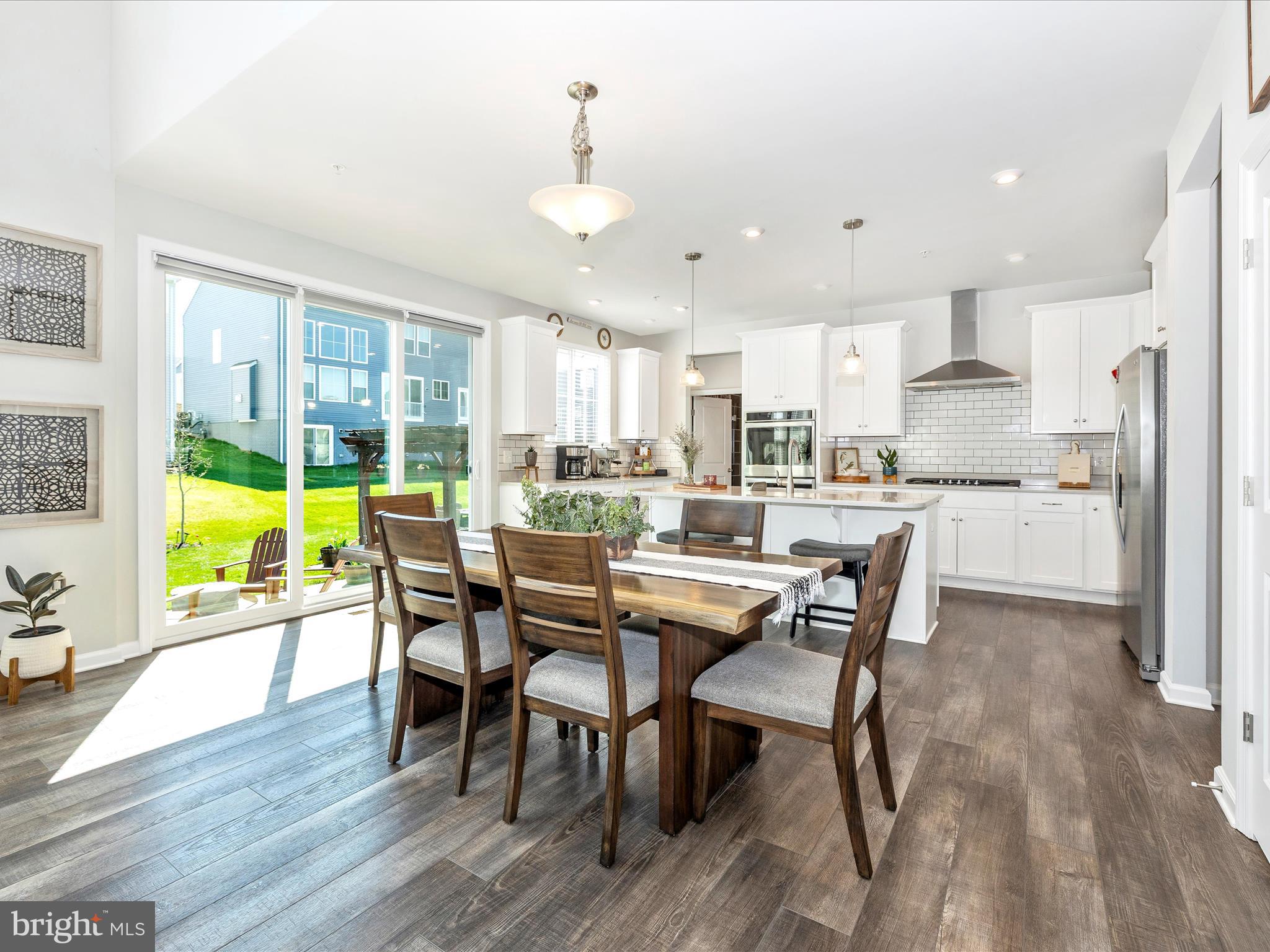 5816 Hawk Ridge Road Frederick, MD 21704 - Photo 14 of 97 a kitchen with stainless steel appliances granite countertop table chairs and wooden floor