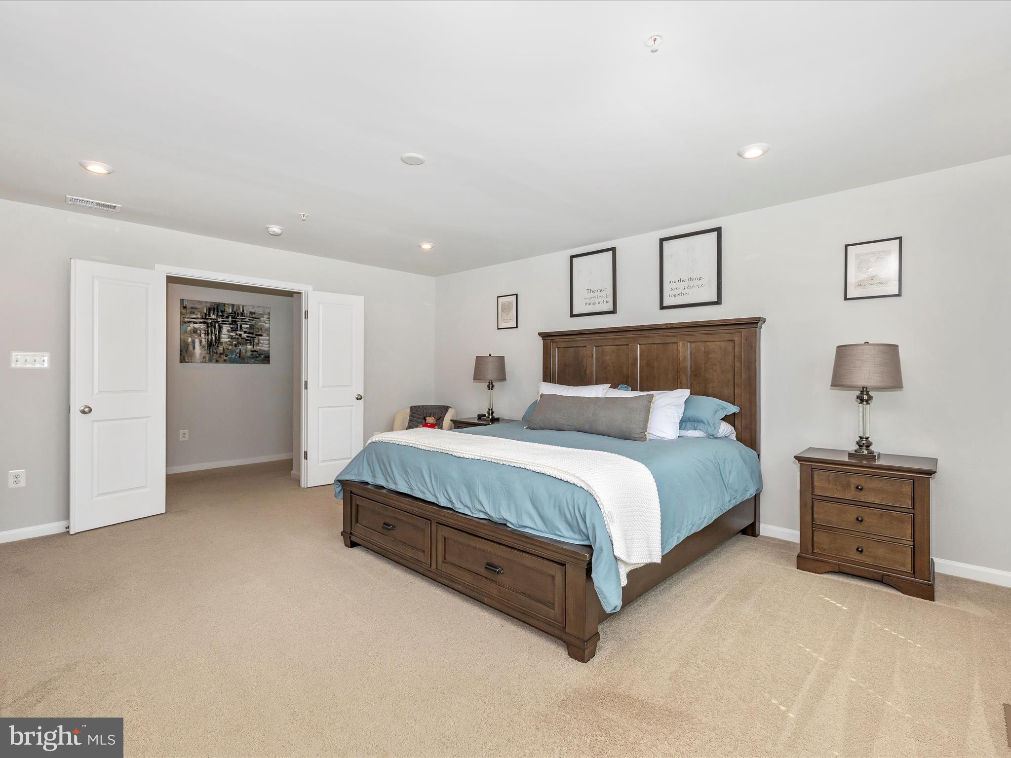 5816 Hawk Ridge Road Frederick, MD 21704 - Photo 26 of 97 a spacious bedroom with a bed and a lamp on dresser