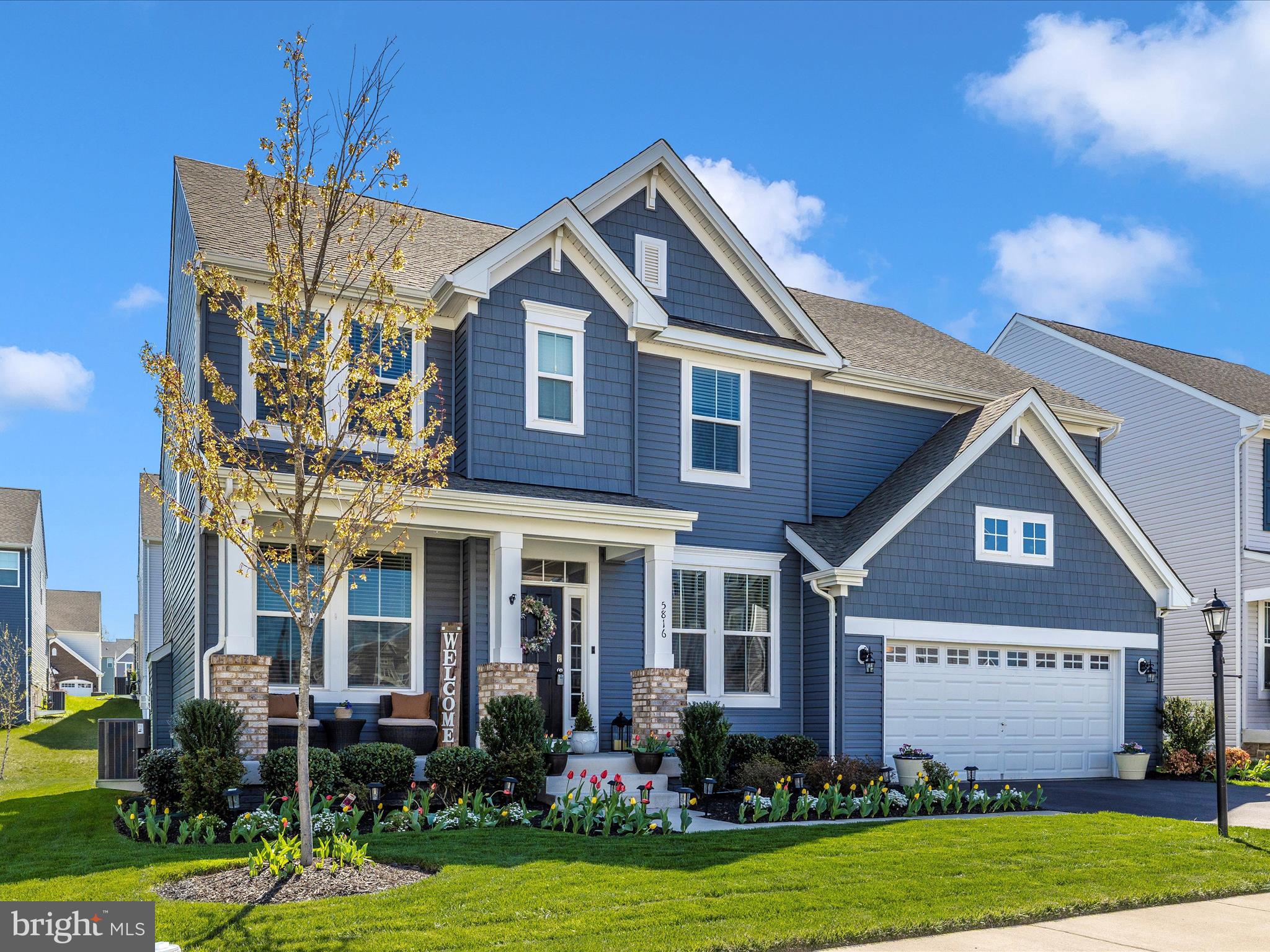 5816 Hawk Ridge Road Frederick, MD 21704 - Photo 48 of 97 a front view of a house with a yard and garage