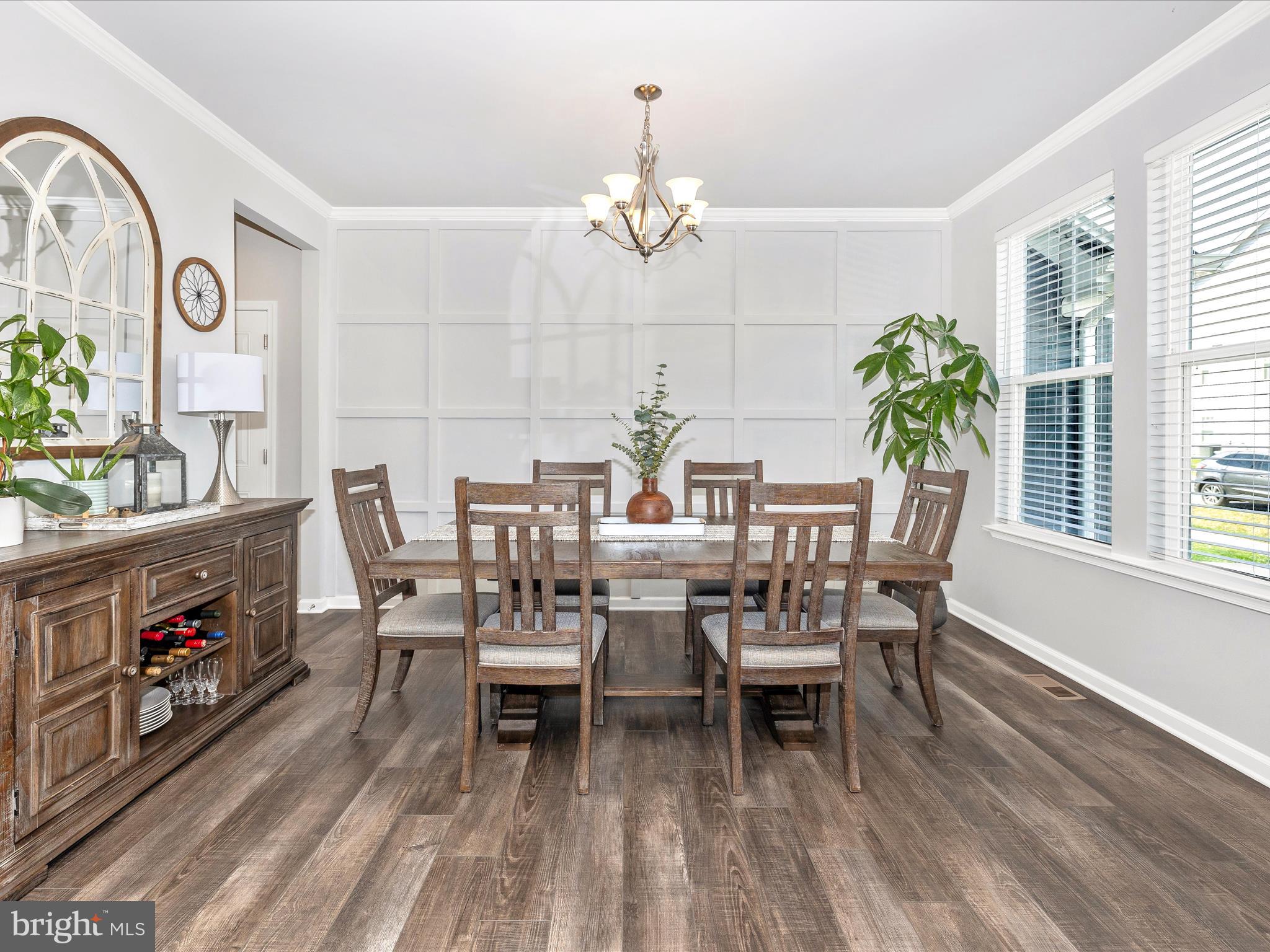 5816 Hawk Ridge Road Frederick, MD 21704 - Photo 7 of 97 a dining room with wooden floor a chandelier a wooden table and chairs