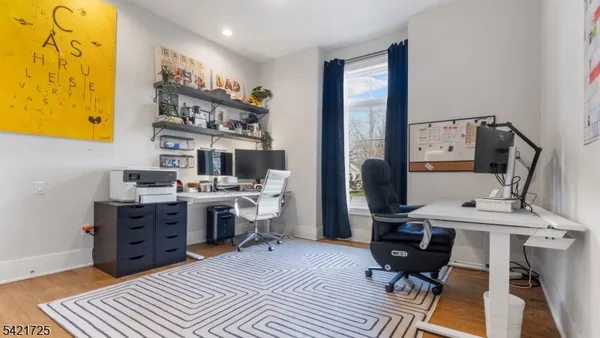 a spacious bedroom with a bed a table and large window