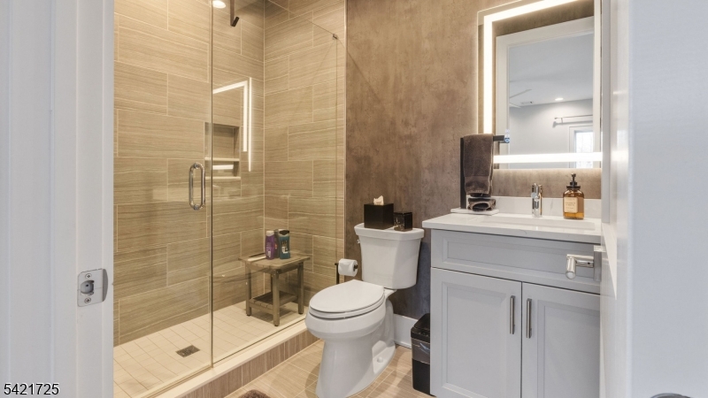 7 Woodcrest Road Florham Park, NJ 07932 - Photo 39 of 50 a bathroom with a toilet sink vanity and shower