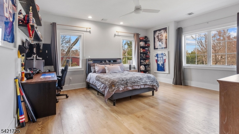 7 Woodcrest Road Florham Park, NJ 07932 - Photo 40 of 50 a bedroom with a large bed and a flat tv screen