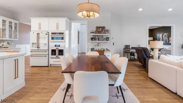 a view of a dining room with furniture wooden floor and chandelier