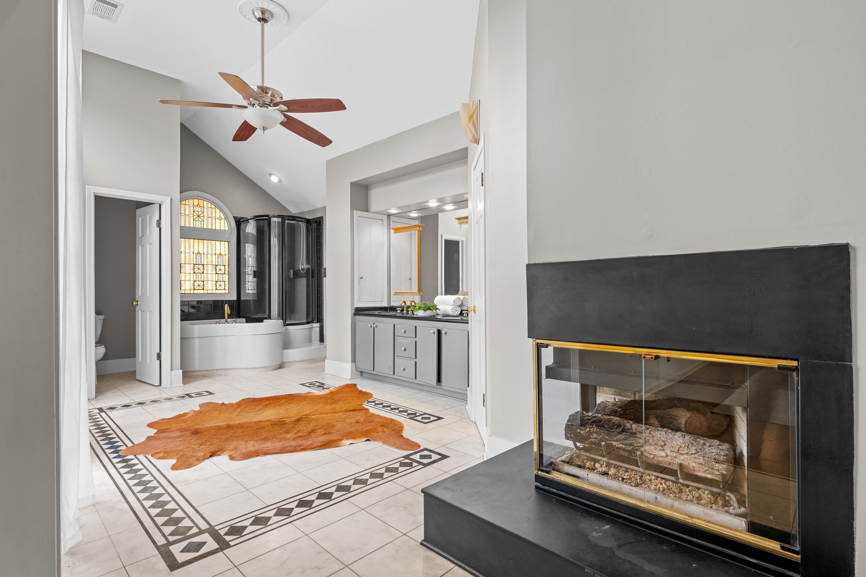 179 Ericson Road Memphis, TN 38018 - Photo 20 of 39 a living room with a rug kitchen view and a fireplace