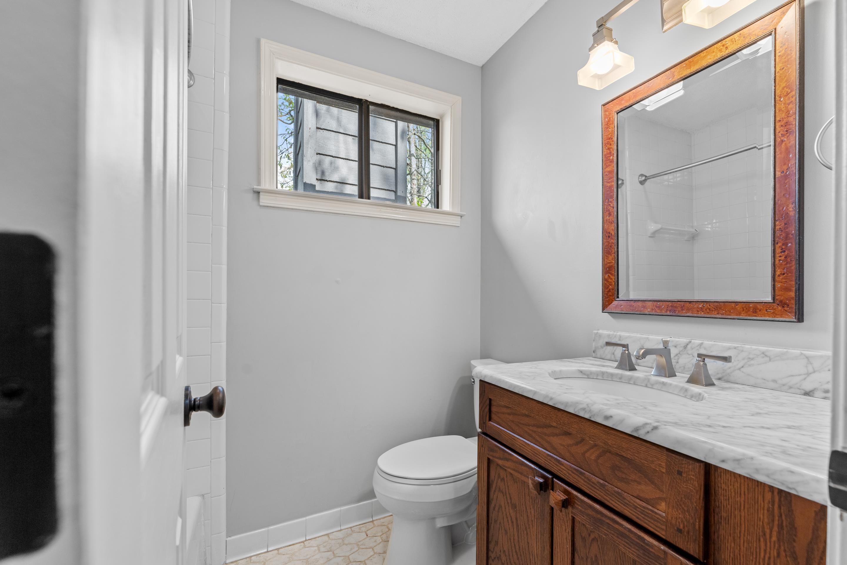 179 Ericson Road Memphis, TN 38018 - Photo 26 of 39 a bathroom with a granite countertop toilet sink and mirror
