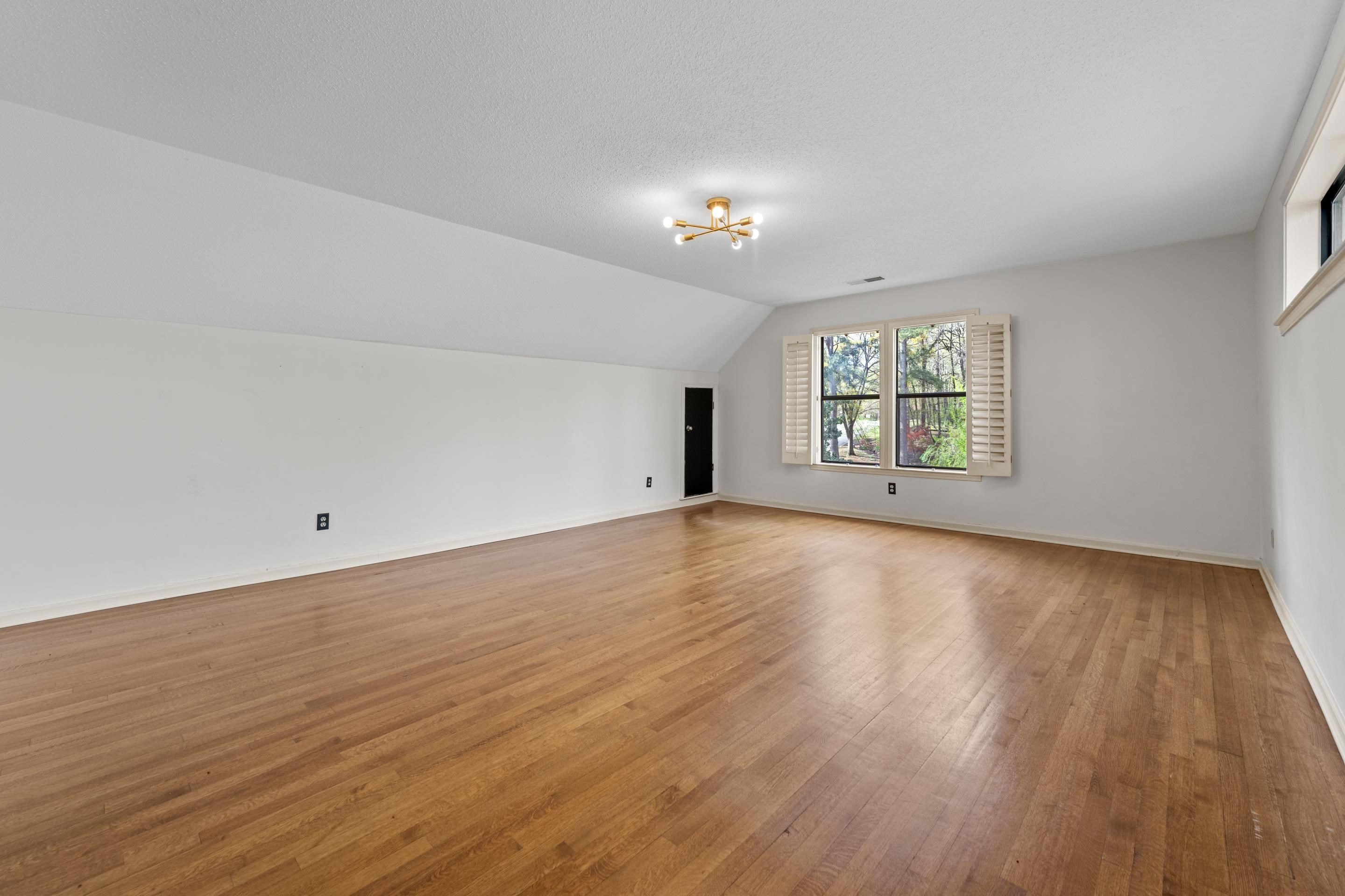 179 Ericson Road Memphis, TN 38018 - Photo 28 of 39 an empty room with wooden floor and windows