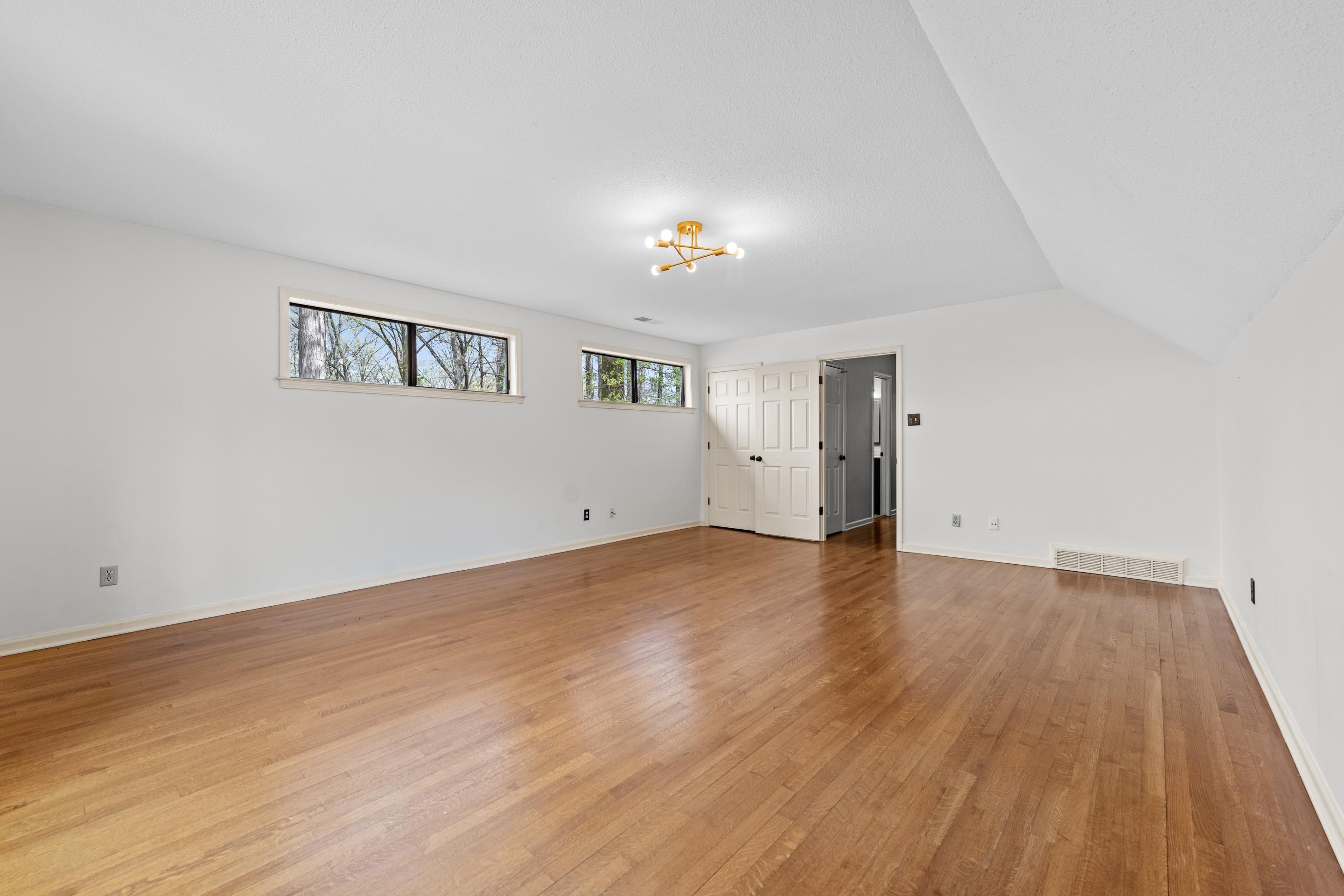 179 Ericson Road Memphis, TN 38018 - Photo 29 of 39 a view of empty room with wooden floor and fan