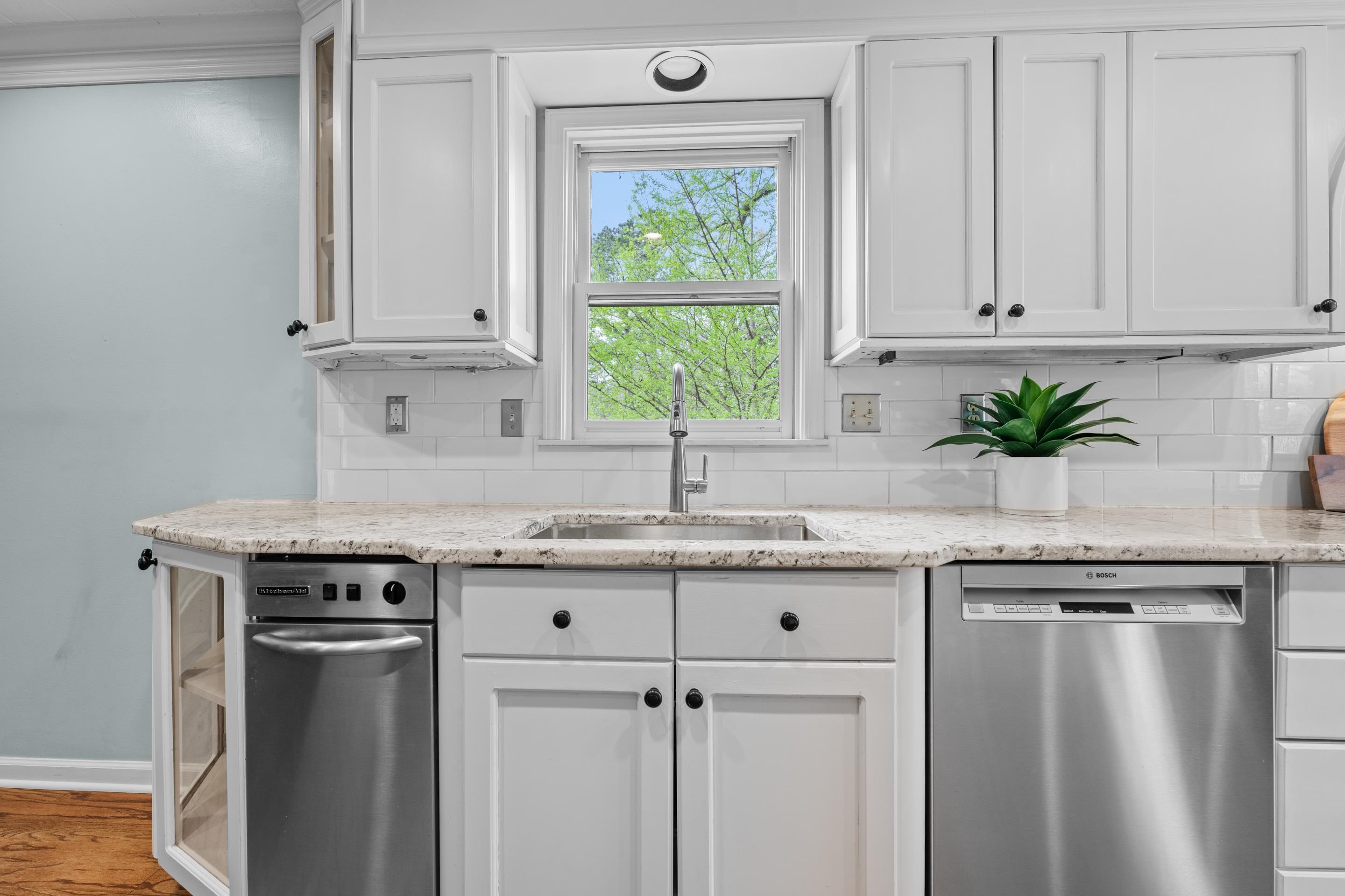 179 Ericson Road Memphis, TN 38018 - Photo 9 of 39 a kitchen with granite countertop a sink white cabinets and window