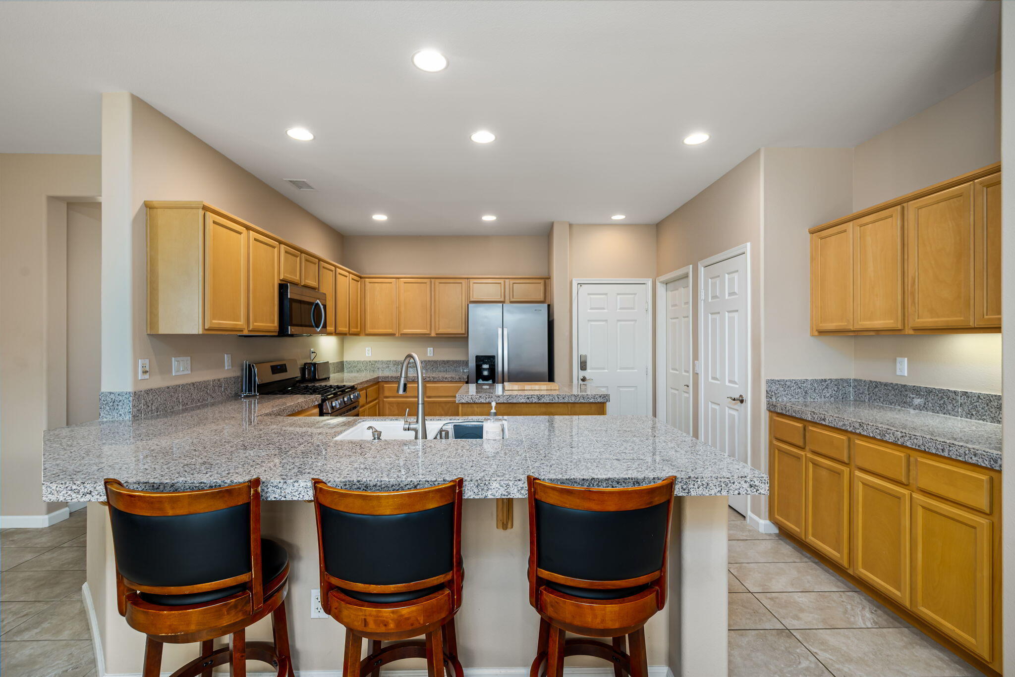 60237 Angora Court La Quinta, CA 92253 - Photo 12 of 75 a kitchen with a dining table chairs and window