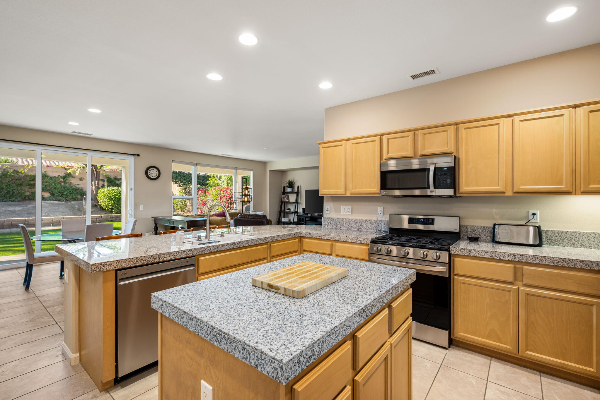 60237 Angora Court La Quinta, CA 92253 - Photo 15 of 75 a kitchen with stainless steel appliances granite countertop a sink stove and cabinets